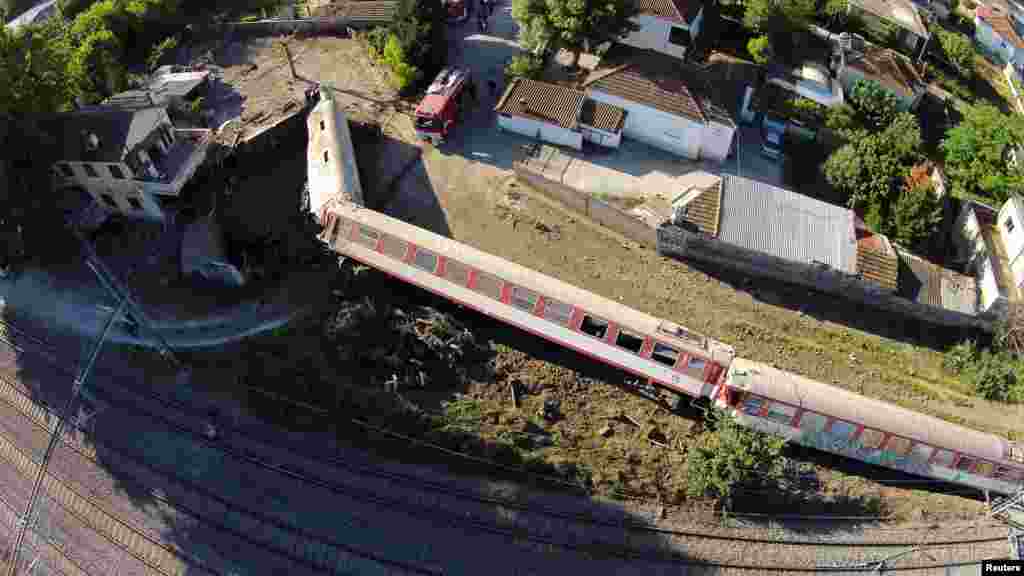 A train has toppled on its side after derailing and crashing into a house in the town of Adendro in northern Greece.