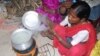 FILE - A woman in India is uses a cookstove that produces less smoke for burning wood or any other fuel. 