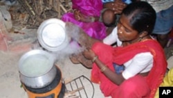 FILE - A woman in India is uses a cookstove that produces less smoke for burning wood or any other fuel. 