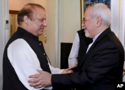 Visiting Iranian Foreign Minister Mohammad Javad Zarif, right, shakes hand with Pakistani Prime Minister Nawaz Sharif prior to their meeting in Islamabad, May 3, 2017.