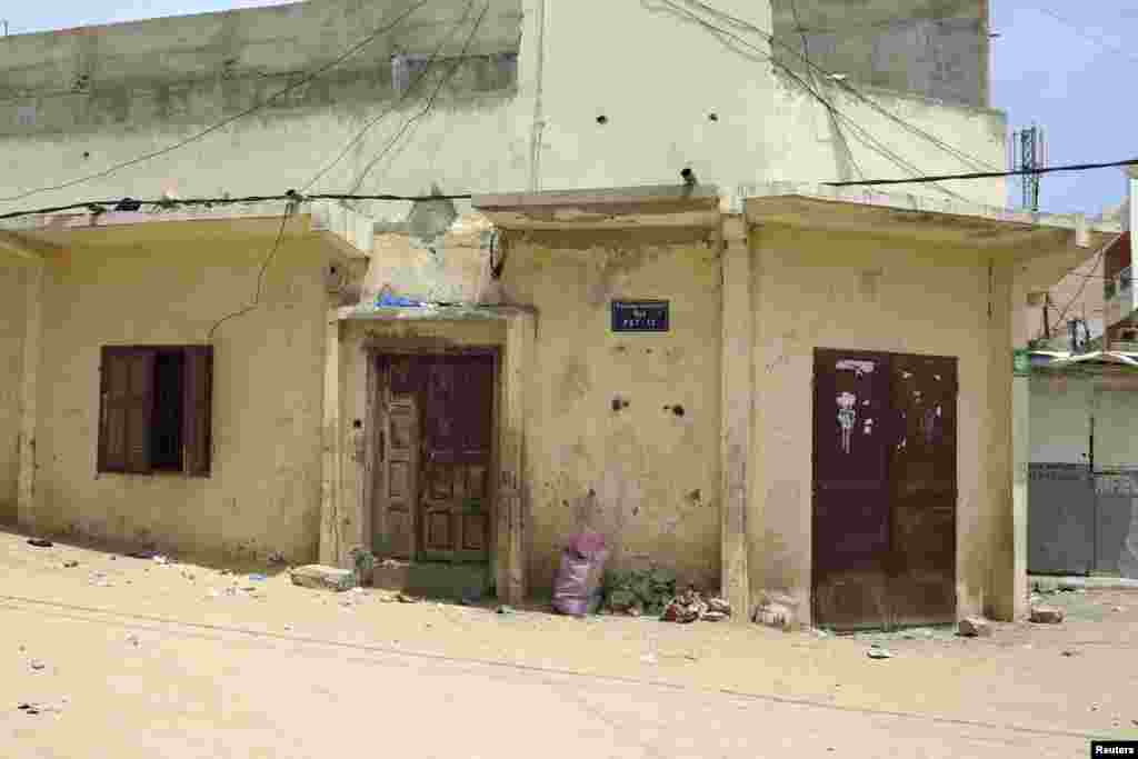 This house, a family compound, is where 33 people are being quarantined after a 21-year-old student from Guinea infected with the Ebola virus came to stay with his uncle about two weeks ago, in Dakar, Senegal, Sept. 2, 2014.