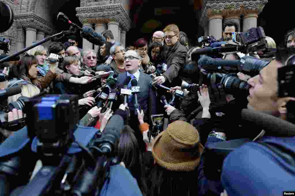 John Norris (C), the lawyer of suspect Raed Jaser, speaks to the media outside Old City Hall Court, following his client's brief appearance in court in Toronto. Two men charged in Canada with plotting an attack on a passenger train will appear in court for bail hearings, while questions swirl about their background and reported links to al Qaeda elements in Iran.