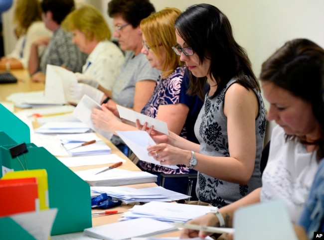 Election workers count mail-in ballots at the conclusion of European elections in Budapest, Hungary, May 26, 2019.