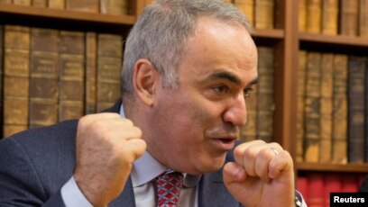 Former World Chess Champion, Garry Kasparov, right, talks to the