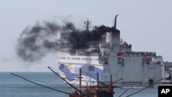 A ship carrying Chinese workers leaves Vung Ang port, Ha Tinh province, Vietnam, May 19, 2014.