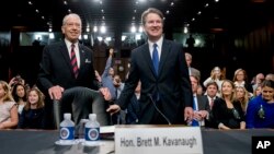 President Donald Trump's Supreme Court nominee, Brett Kavanaugh, a federal appeals court judge, right, accompanied by Senate Judiciary Chairman Chuck Grassley, R-Iowa, left, on Capitol Hill.