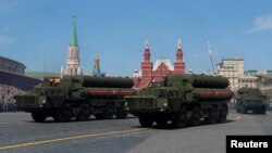 FILE - Russian servicemen drive S-400 missile air defense systems during the Victory Day parade in Moscow, May 9, 2018.