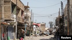 Debris is seen on a street controlled by Iraqi forces fighting the Islamic State in Mosul, Iraq, April 6, 2017. 