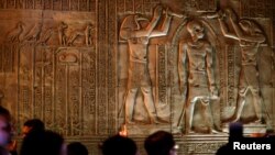 FILE - Tourists examine part of the Kom Ombo Temple, southern Egypt, November 7, 2009. The temple, which dates from about 180 B.C. during the Ptolemaic era stands on the bank of the Nile between Edfu and Aswan.