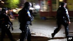 European Union rule of law mission (EULEX) police officers arrive at a vandalized polling station in the northern, Serb-dominated part of Mitrovica, Kosovo, Nov. 3, 2013.