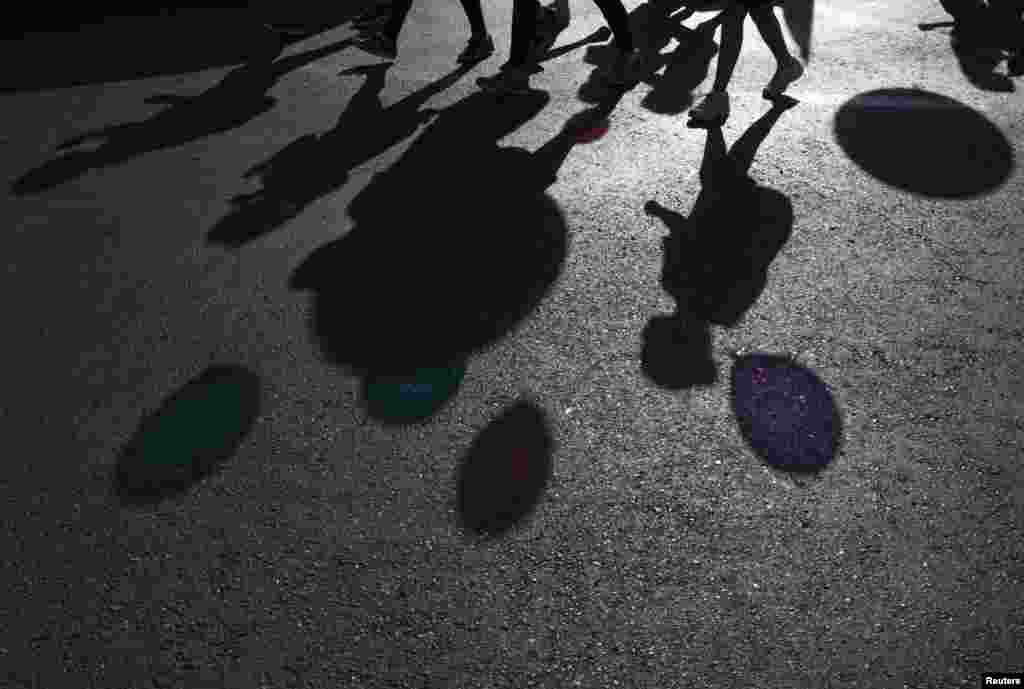 Shadows of participants holding balloons are cast on a street at an annual parade during the Jewish holiday of Sukkot in Jerusalem October 4, 2012.