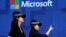 FILE- In this May 11, 2017, file photo, members of a design team at Cirque du Soleil demonstrate use of Microsoft's HoloLens device in helping to virtually design a set at the Microsoft Build 2017 developers conference in Seattle. Federal contract records