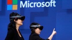 FILE- In this May 11, 2017, file photo, members of a design team at Cirque du Soleil demonstrate use of Microsoft's HoloLens device in helping to virtually design a set at the Microsoft Build 2017 developers conference in Seattle. Federal contract records