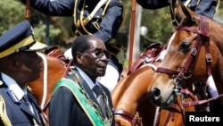 FILE - Zimbabwe's President Robert Mugabe arrives for the opening of Parliament in Harare, Zimbabwe, Oct. 6, 2016. 