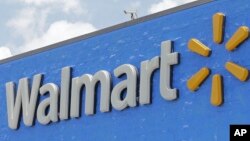 FILE- The Walmart sign is shown on June 1, 2017, in Hialeah Gardens, Fla. 