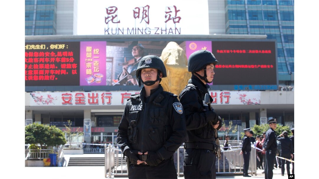 FILE - Armed police stand guard at China's Kunming railway station in Yunnan province, March 2, 2014. A day earlier, assailants slashed scores of people there, ultimately killing 31.