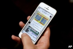 FILE - An Iranian man shows Telegram app messages on his mobile phone in Tehran, Feb. 24, 2016.