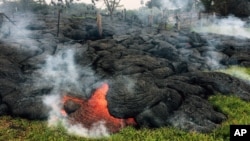 This photo provided by the U.S. Geological Survey shows the lava flow front of from an eruption that began the June 27, as the front remains active and continues to advance towards the northeast threatening the town of Pahoa on Hawaii's Big Island, Oct. 26, 2014.