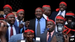 FILE - Ugandan Members of Parliament opposed to the extension of presidential age limits wear red bandannas, which they said signified their willingness to die in defense of the constitution, at the Parliament building in Kampala, Uganda, Sept. 21, 2017. 