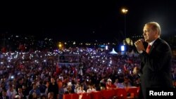 Turkish President Recep Tayyip Erdogan addresses his supporters during a ceremony marking the first anniversary of an attempted coup at the Bosporus Bridge in Istanbul, July 15, 2017.