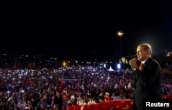Turkish President Recep Tayyip Erdogan addresses his supporters during a ceremony marking the first anniversary of an attempted coup at the Bosporus Bridge in Istanbul, July 15, 2017.