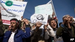 Yemenis chant slogans during a protest against caricatures published in French magazine Charlie Hebdo in front of the French Embassy in Sanaa, Yemen, Saturday, Jan. 17, 2015.