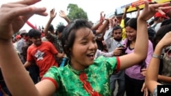 A Unified Communist Party of Nepal (Maoist) supporter dances during an indefinite nationwide general strike by Maoist in Kathmandu on 2 May 2010