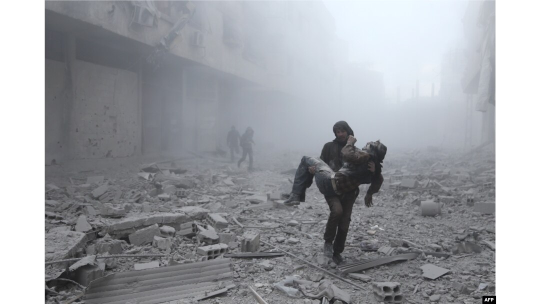 FILE - A wounded man is carried following an air strike on the rebel-held besieged town of Arbin, in the eastern Ghouta region on the outskirts of the capital Damascus on January 2, 2018.