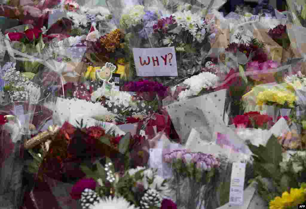 Floral tributes are placed close to the scene of a truck accident in Glasgow. Flags were flown at half mast above Scottish government buildings to remember six people killed when an out-of-control truck ploughed into Christmas shoppers on Dec. 22, 2014.