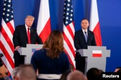 U.S. President Donald Trump and Polish President Andrzej Duda listen to questions from journalists during a joint news conference, in Warsaw, Poland, July 6, 2017.