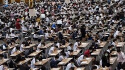 Middle school students wear protective masks as they take an entrance examination for high school in Bangkok, Thailand, Thursday, March 5, 2020.