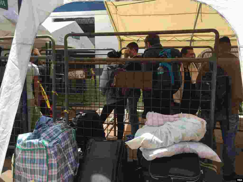 A las afueras del centro de control migratorio del lado ecuatoriano de la frontera en Rumichaca, viajeros e inmigrantes esperan su turno para ser registrados por el servicio de inmigración. (Foto: Alejandra Arredondo/VOA)