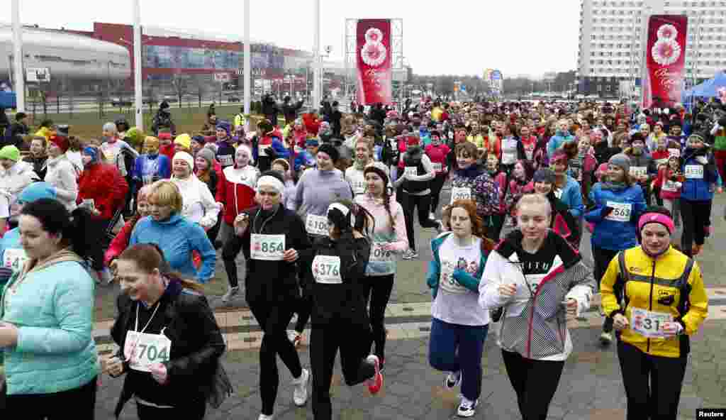 Women run as they take part in the "Beauty run" event in Minsk, Belarus, March 8, 2016. About 900 women gathered to mark International Women's Day by running a distance of 5300 meters.