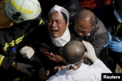 A relative cries after his family member was confirmed dead at a 17-storey apartment building that collapsed after an earthquake hit Tainan, southern Taiwan, Feb. 7, 2016.