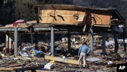 Masahiko Horio, president of Horio Seisakushou Co., Ltd, walks around the remains of a subcontract factory destroyed by the March 11 tsunami waters at Ogatsu town in Ishinomaki, Miyagi Prefecture, northern Japan. (Mar 2011 file photo)