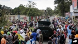 Demonstrators celebrate what they perceive to be an attempted military coup, with army soldiers riding in an armored vehicle in Bujumbura, Burundi, May 13, 2015.