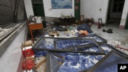 A damaged room in a residential building is seen after several locations were targeted with parcel bombs in the southwestern city of Liuzhou, Guangxi province, Sept. 30, 2015.