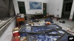 A damaged room in a residential building is seen after several locations were targeted with parcel bombs in the southwestern city of Liucheng, Guangxi province, Sept. 30, 2015.