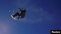 A snowboarder jumps during a training session on the Stubai glacier in Mutterberg, Austria, Nov. 3, 2017.