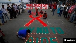 Children light candles during an HIV/AIDS awareness campaign on the occasion of World AIDS Day in Kolkata, India, December 1, 2017.
