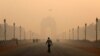 A man walks in front of the India Gate shrouded in smog in New Delhi, India, Oct. 29, 2018.