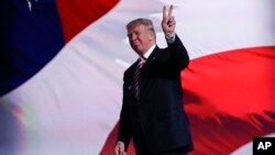 FILE - Republican Presidential Candidate Donald Trump stands on stage during the third day session of the Republican National Convention in Cleveland.