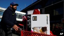 A man pushes a cart full of goods after shopping at a Target store during Black Friday in Brooklyn, N.Y., Nov. 24, 2017. 