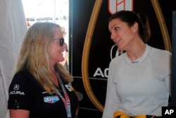 Team owner Jackie Heinricher, left, talks with Katherine Legge, of England, during a test session at Daytona International Speedway in Daytona Beach, Florida, January 4, 2019. (AP Photo/Mark Long)
