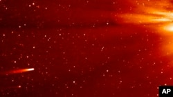In this frame grab taken from enhanced video made by NASA's STEREO-A spacecraft, comet ISON, left, approaches the sun on Nov. 25, 2013. Comet Encke is shown just below ISON, the sun is to the right, just outside the frame. 