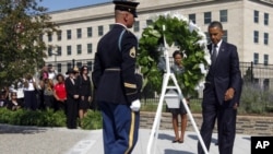 President Barack Obama and first lady Michelle Obama lay a wreath as the 10th anniversary of the Sept. 11 attacks are observed at the Pentagon in Washington, Sunday, Sept. 11, 2011.