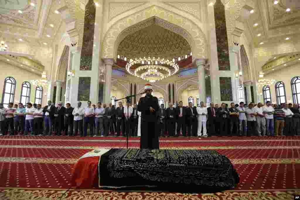 Mourners pray over the coffin of Egyptian actor Omar Sharif, 83, for a funeral procession at the Hussein Tantawi Mosque in Cairo. Sharif, the Egyptian-born actor with the dark, soulful eyes who soared to international stardom in movie epics, &quot;Lawrence of Arabia&quot; and &quot;Doctor Zhivago,&quot; died in a Cairo hospital of a heart attack, on July 10.