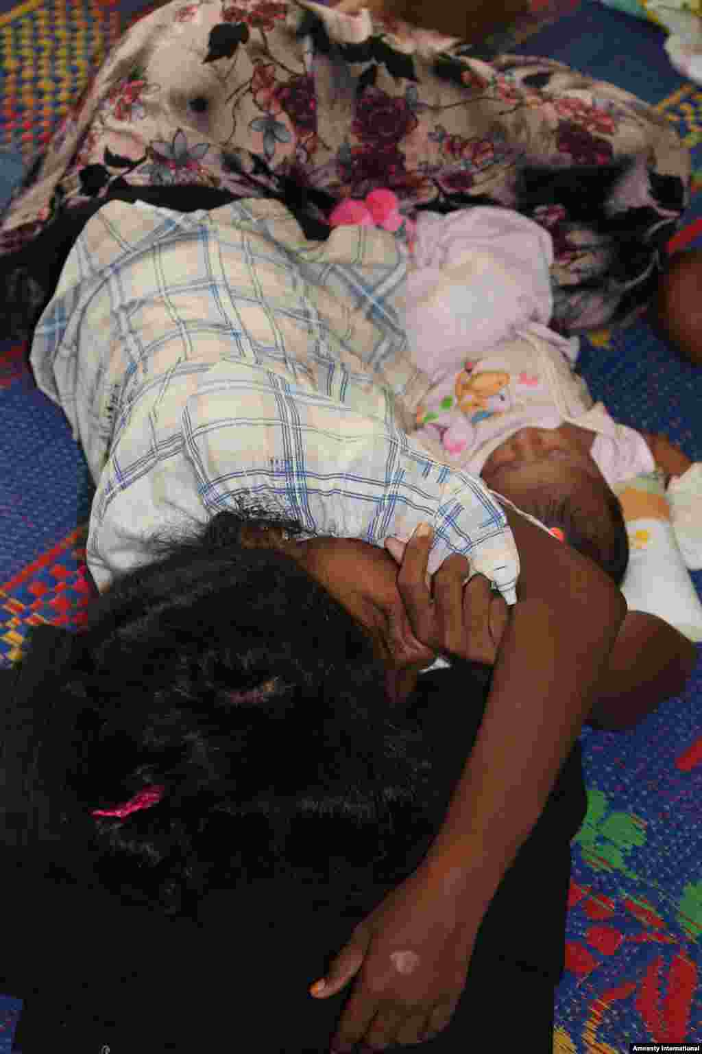Rohingya mother and newborn in Aceh.