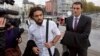 FILE - Co-defendant and key witness Jejoen Bontinck, left, arrives with his lawyer Kris Luyckx to the main courthouse in Antwerp, Belgium on Monday, Sept. 29, 2014