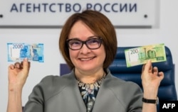 Russia's Central bank chief Elvira Nabiullina presents the new 2,000 and 200 ruble banknotes in Moscow on Oct. 12, 2017.